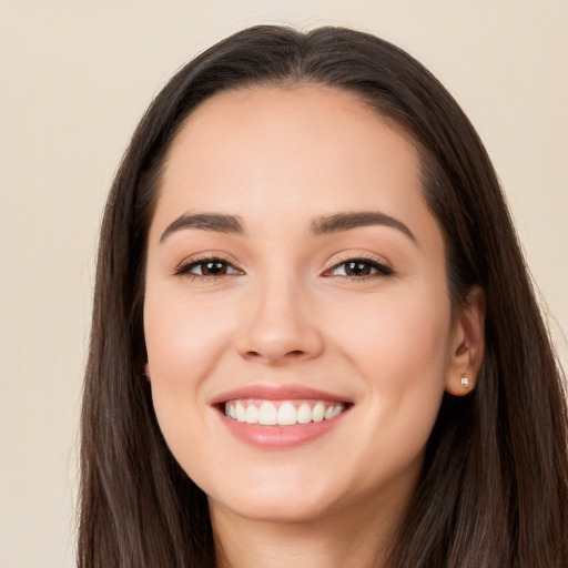 Joyful white young-adult female with long  brown hair and brown eyes