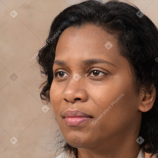 Joyful black adult female with medium  brown hair and brown eyes