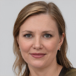 Joyful white adult female with medium  brown hair and grey eyes