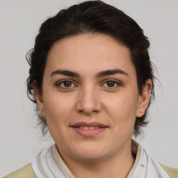 Joyful white young-adult female with medium  brown hair and brown eyes