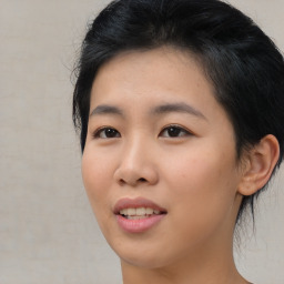 Joyful asian young-adult female with short  black hair and brown eyes