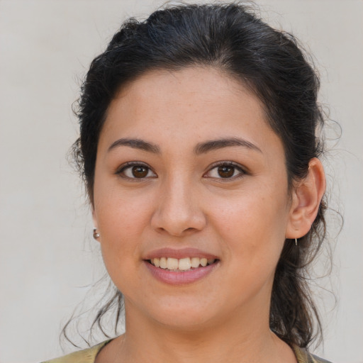 Joyful latino young-adult female with medium  brown hair and brown eyes