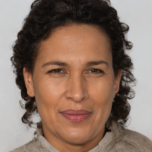 Joyful latino adult female with short  brown hair and brown eyes