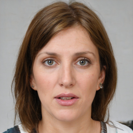 Joyful white young-adult female with medium  brown hair and blue eyes