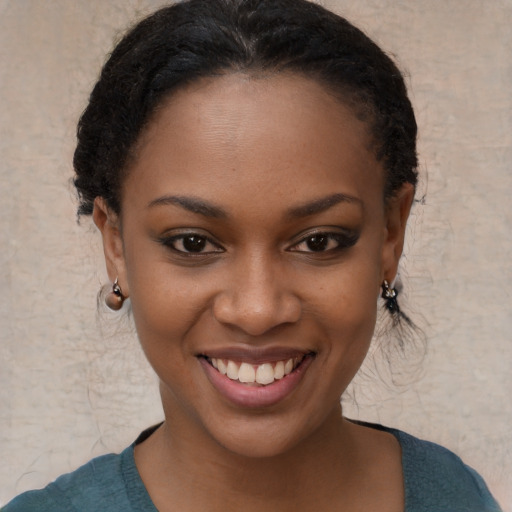 Joyful black young-adult female with short  brown hair and brown eyes