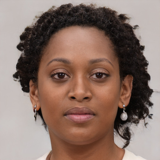 Neutral black young-adult female with medium  brown hair and brown eyes