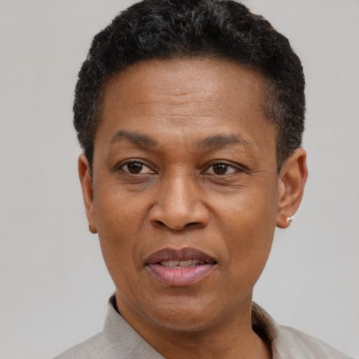 Joyful black adult male with short  brown hair and brown eyes