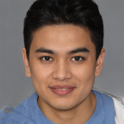 Joyful latino young-adult male with short  brown hair and brown eyes