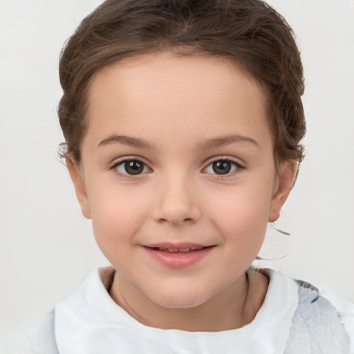 Joyful white child female with short  brown hair and brown eyes