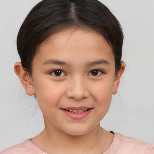 Joyful white child female with short  brown hair and brown eyes