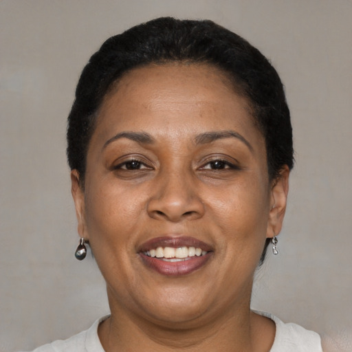 Joyful latino adult female with short  brown hair and brown eyes