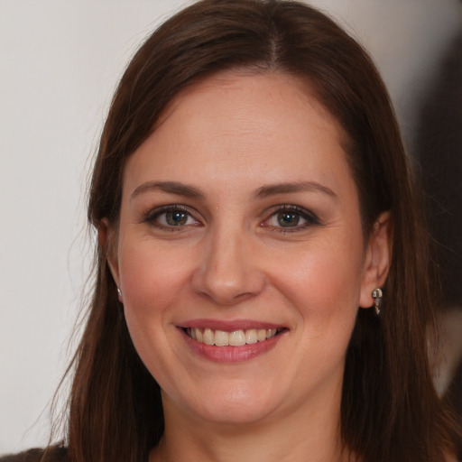 Joyful white young-adult female with long  brown hair and brown eyes