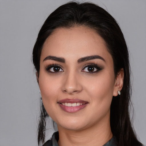 Joyful white young-adult female with long  black hair and brown eyes