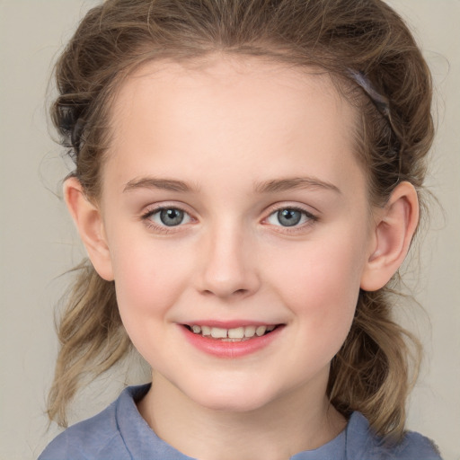 Joyful white child female with medium  brown hair and grey eyes