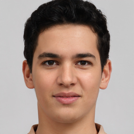 Joyful latino young-adult male with short  brown hair and brown eyes