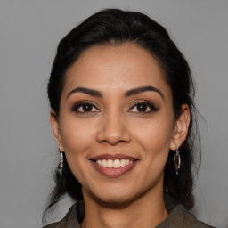 Joyful latino young-adult female with medium  black hair and brown eyes