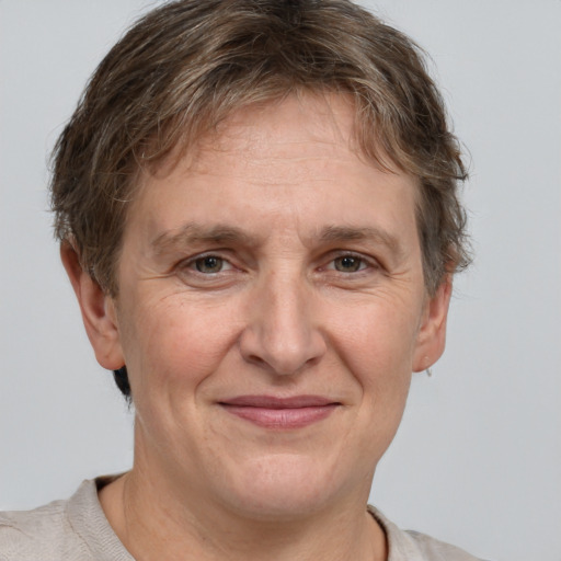 Joyful white adult female with short  brown hair and grey eyes