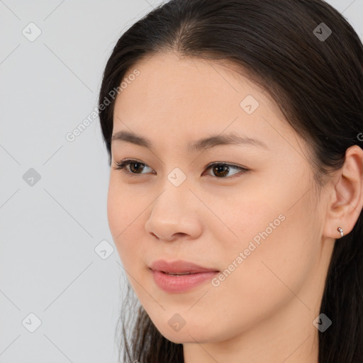 Joyful asian young-adult female with long  brown hair and brown eyes