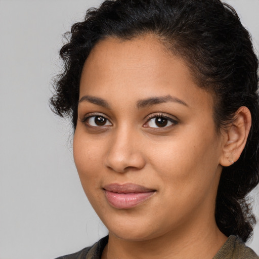 Joyful latino young-adult female with medium  brown hair and brown eyes