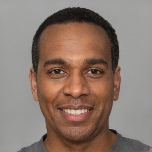 Joyful latino adult male with short  black hair and brown eyes