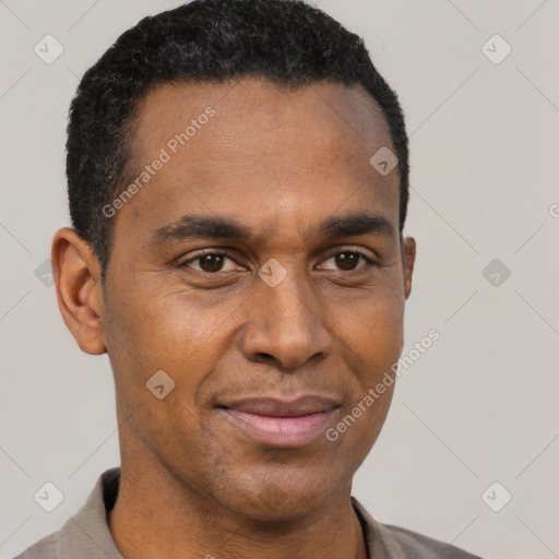 Joyful black adult male with short  brown hair and brown eyes