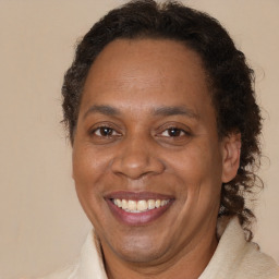 Joyful black adult male with short  brown hair and brown eyes