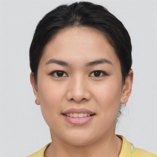 Joyful asian young-adult female with short  brown hair and brown eyes