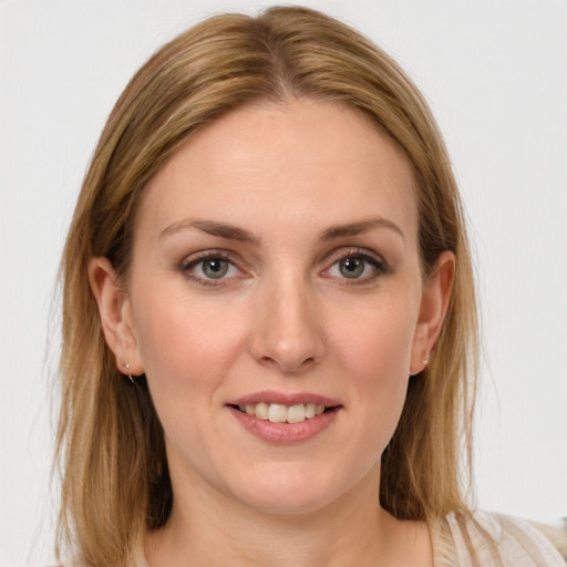 Joyful white young-adult female with medium  brown hair and blue eyes