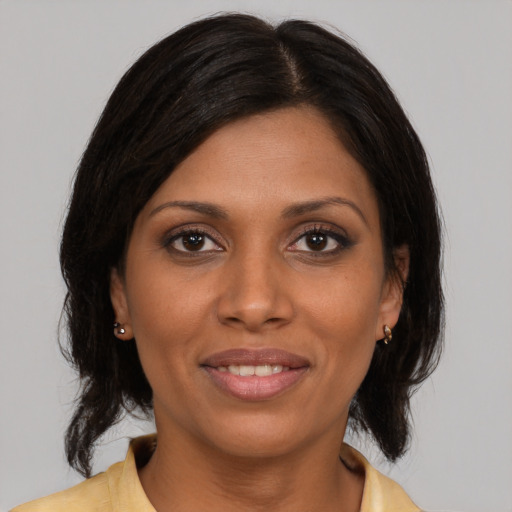 Joyful latino young-adult female with medium  brown hair and brown eyes