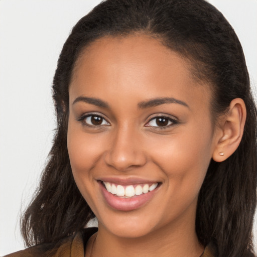 Joyful latino young-adult female with long  brown hair and brown eyes