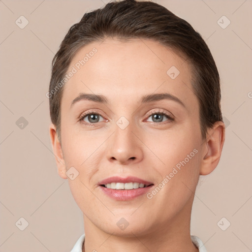 Joyful white young-adult female with short  brown hair and brown eyes