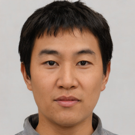 Neutral asian young-adult male with short  brown hair and brown eyes