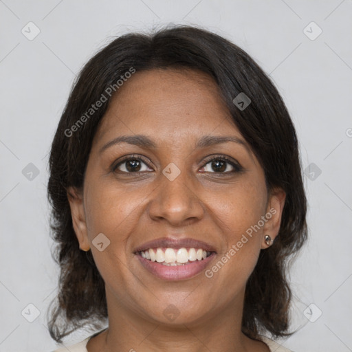 Joyful black adult female with medium  brown hair and brown eyes