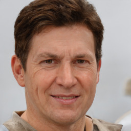 Joyful white adult male with short  brown hair and grey eyes