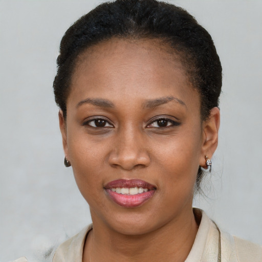 Joyful black young-adult female with short  brown hair and brown eyes