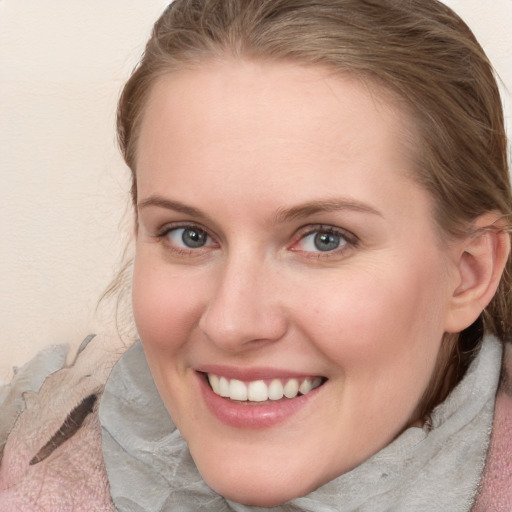 Joyful white young-adult female with medium  brown hair and blue eyes