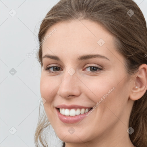 Joyful white young-adult female with long  brown hair and grey eyes