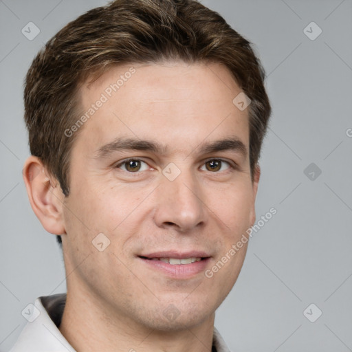 Joyful white young-adult male with short  brown hair and grey eyes