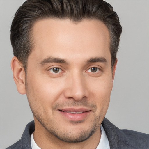 Joyful white young-adult male with short  brown hair and brown eyes