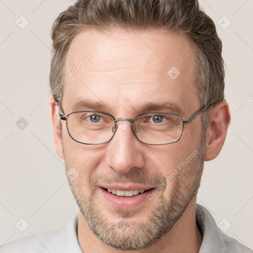 Joyful white adult male with short  brown hair and grey eyes