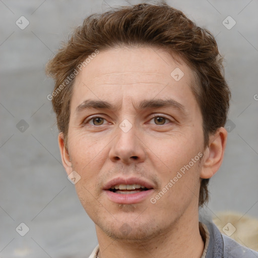 Joyful white adult male with short  brown hair and grey eyes