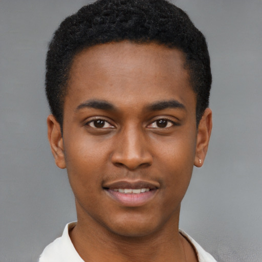 Joyful black young-adult male with short  brown hair and brown eyes