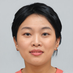 Joyful asian young-adult female with short  black hair and brown eyes