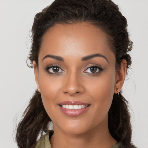 Joyful white young-adult female with long  brown hair and brown eyes