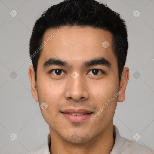 Joyful latino young-adult male with short  black hair and brown eyes