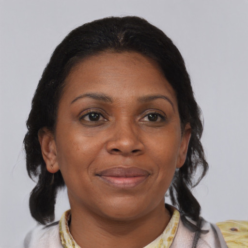 Joyful black adult female with medium  brown hair and brown eyes