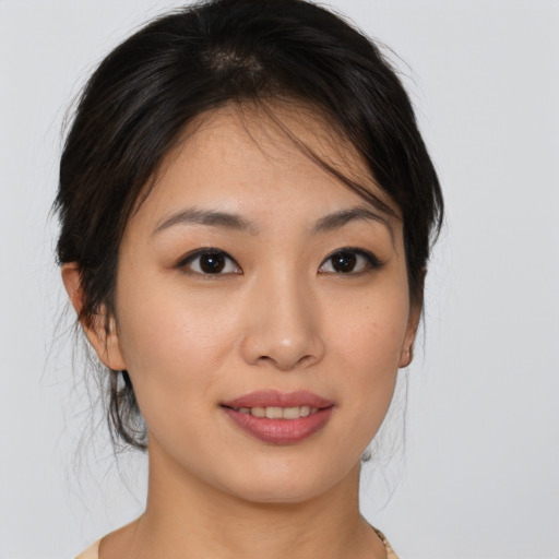 Joyful asian young-adult female with medium  brown hair and brown eyes