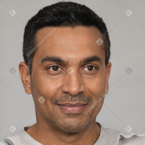 Joyful latino adult male with short  black hair and brown eyes