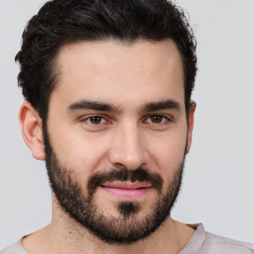 Joyful white young-adult male with short  black hair and brown eyes