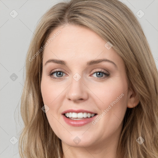 Joyful white young-adult female with long  brown hair and green eyes